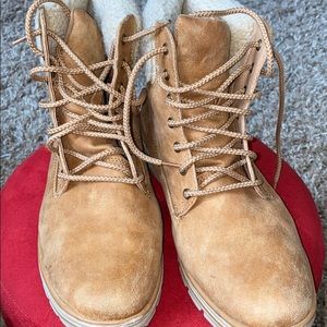 Tan hiker style boots with fur